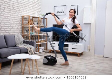 Stok fotoğraf: Janitor Dancing With Vacuum Cleaner