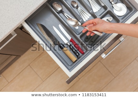 Foto d'archivio: Girl Open The Kitchen Drawer