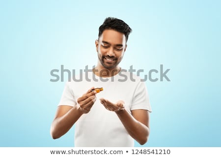 Stockfoto: Indian Man Applying Grooming Oil To His Hand