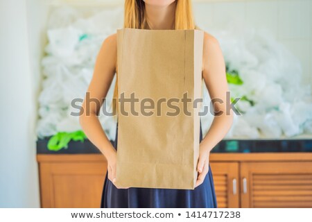 Stock photo: Paper Bag Amid A Pile Of Plastic Bags Zero Waste Concept The Concept Of World Environment Day