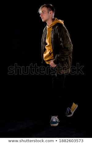 Foto stock: Young Modern Style Macho Man Is Posing Studio Shot