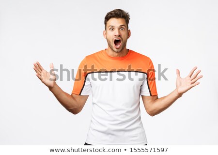 Stok fotoğraf: Excited Speechless Handsome Bearded Young Guy In Sportswear Wearing Sports T Shirt Drop Jaw Gasp