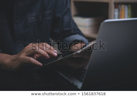 Foto d'archivio: Close Up Of Man Working With Tablet Pc At Home
