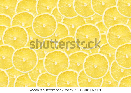Foto stock: Lemon Slices Pattern On Vibrant Green Color Background