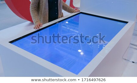 Foto d'archivio: Hands Touching Interactive Table