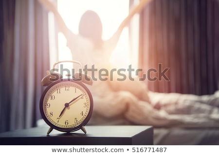 Foto d'archivio: Young Sleeping Woman And Alarm Clock In Bedroom At Home