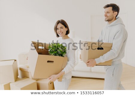 Stock foto: Photo Of Family Couple Carry Big Boxes With Households Items And Personal Belongings Move Into New