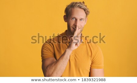 ストックフォト: Bearded Man In Blue Shirt Showing Silence Gesture