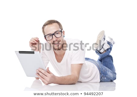 Zdjęcia stock: Smart Nerd Man With Tablet Computer Lying On The Floor