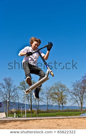 Stock fotó: Child Going Airborne With Scooter