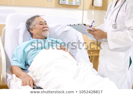 Сток-фото: Senior Man Examining A Clipboard