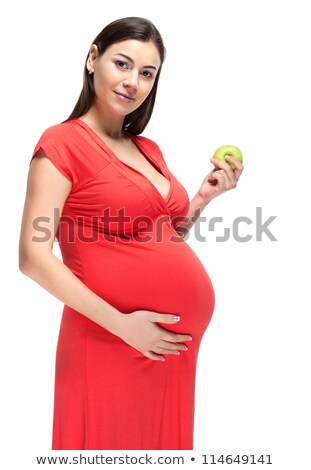 ストックフォト: Happy Young Pregnant Woman In Red Dress Touching Her Belly