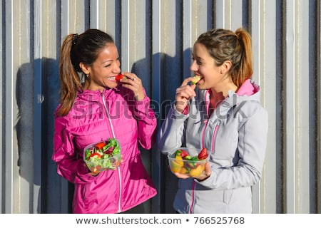 [[stock_photo]]: Two Women Taking A Workout Rest For Eating Healthy Snack