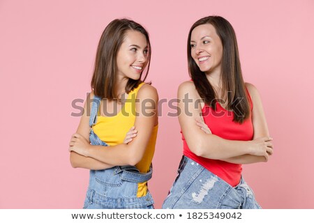 Stockfoto: Image Of Delighted Woman 20s Wearing Casual Clothing Holding Fin