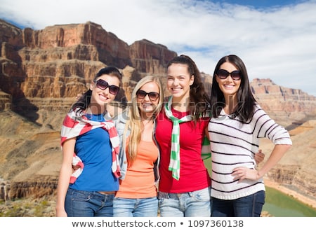 ストックフォト: Happy Friends Hugging Over Grand Canyon