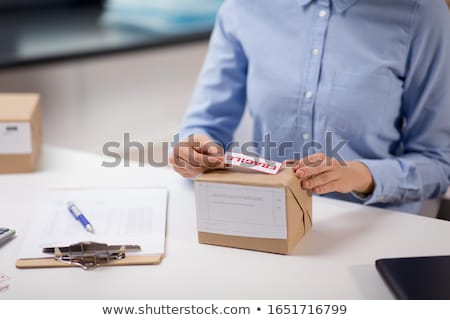 ストックフォト: Woman With A Box Marked Fragile