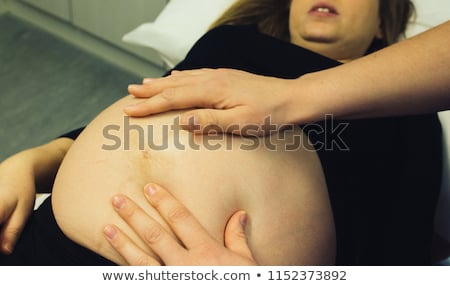 Stockfoto: Midwife Listening At Human Belly