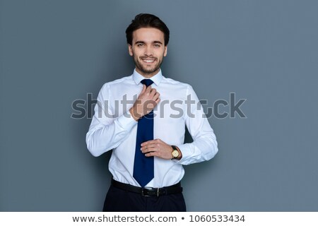 Stok fotoğraf: Man Fixing His Tie