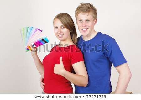 Foto d'archivio: Image Of European Couple Man And Woman Holding Paint Rollers And