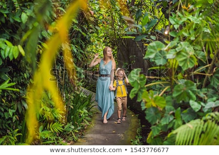 Stockfoto: Mother And Son Tourists In Bali Walks Along The Narrow Cozy Streets Of Ubud Bali Is A Popular Touri