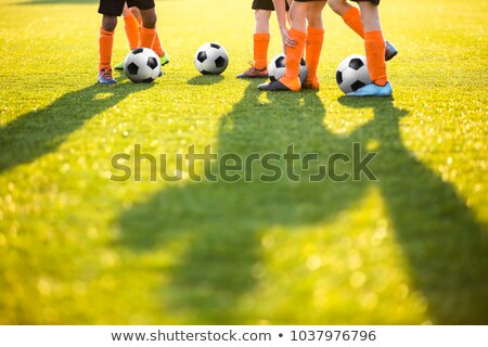 Footballers On Practice Session In Field On Sunny Day Stockfoto © matimix