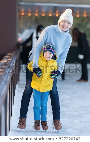 Stock fotó: Young Mother Teaching Her Little Son Ice Skating At Outdoor Skating Rink Family Enjoy Winter On Ice