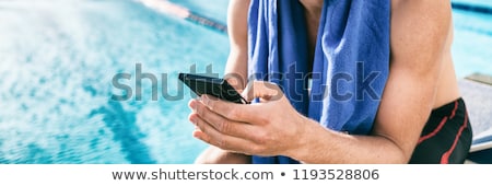 Foto stock: Swimmer Athlete Using Mobile Phone During Triathlon Race Man At Swimming Pool Texting Sms Message O