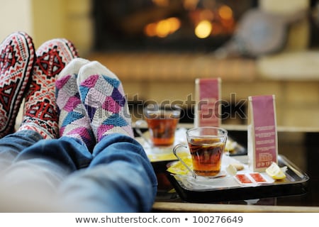 Stockfoto: Young Couple Relaxing By Fire