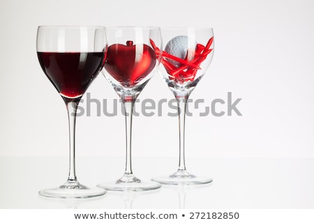 Foto stock: Wine Glasses With Red Wine Heart And Golf Ball