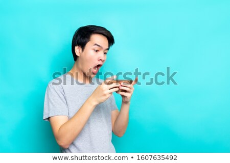 Stock photo: Woman Playing Action Game On Smartphone