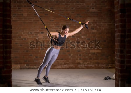 Stock photo: Attractive Young Woman Working Out On Weight Lifting Training Ma