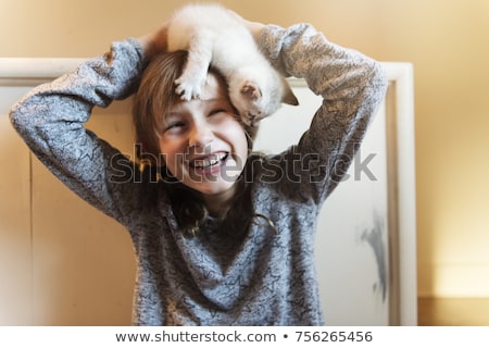 Foto d'archivio: 10 Years Old Girl With Kitten At Home