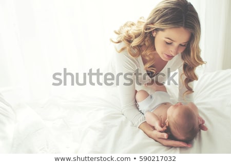 Stockfoto: Portrait Of Beautiful Young Parents And Cute Baby On Bed