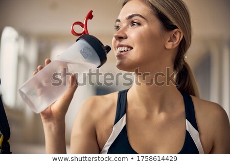 Stock photo: Pretty Young Fit Female In Activewear Exercising With Resistance Band