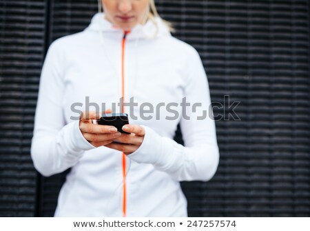 Foto d'archivio: Mid Section Of Woman Using Mobile Phone