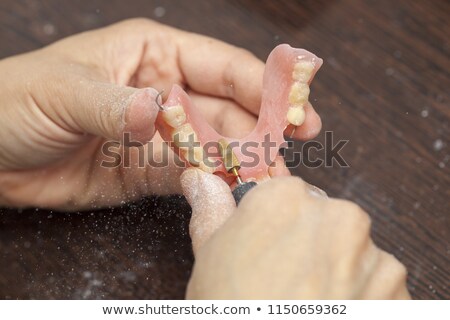Stock foto: Hands Of Dental Technician Make Denture Prothesis In Dental Labo