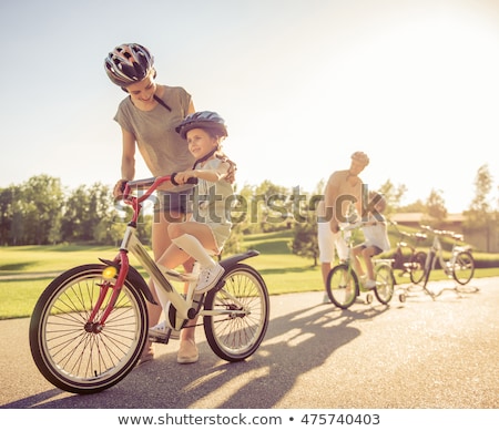 ストックフォト: Dad With Daughter Son Riding Bikes In Park