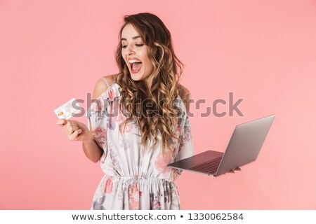 Zdjęcia stock: Image Of Pleased Woman 20s Holding Silver Laptop And Credit Card