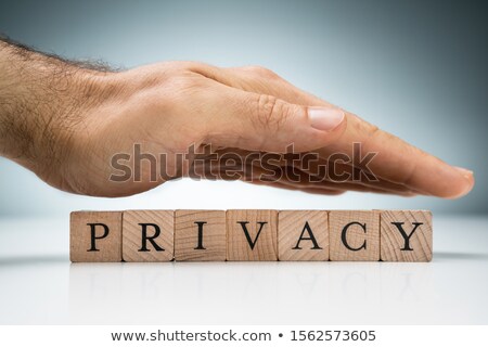 Stock photo: Mans Hand Over The Privacy Wooden Blocks On White Desk