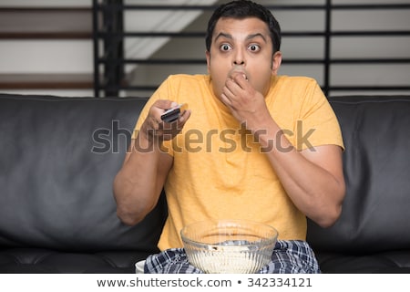 Foto d'archivio: Closeup Portrait Of Young Man Sitting On Sofa