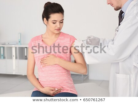 Stock photo: Young Caucasian Woman Receiving An Injection From A Doctor