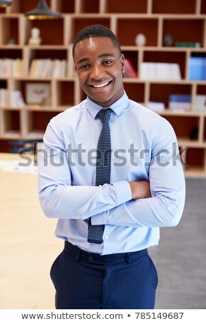 [[stock_photo]]: Businessman With Arms Crossed Standing In Boardroom