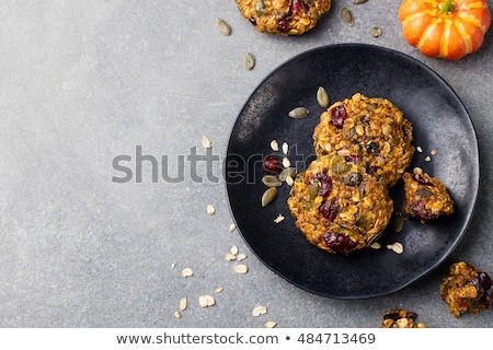 Foto stock: Pumpkin Cookies With Cranberries And Maple Glaze On A Black Plate Grey Stone Background Top View
