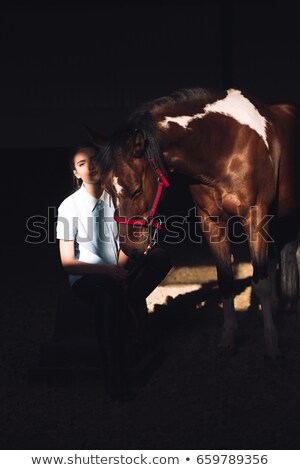 [[stock_photo]]: Amazing Young Girl Sitting Outdoors Hugging Her Horse
