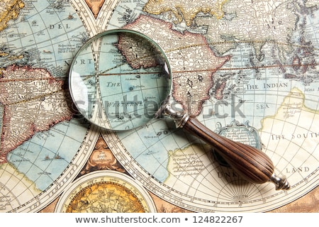 [[stock_photo]]: Old Map With An Magnifying Glass