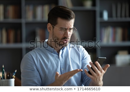 ストックフォト: Young Anxious Businessman Looking At Screen Of Smartphone In Front Of Himself