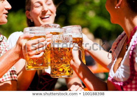 Foto stock: People Drinking Beer In A Traditional Bavarian Beer Garden