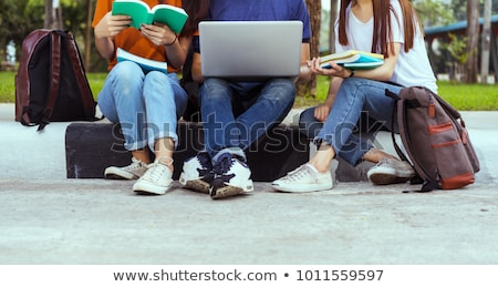 Stock photo: Three Happy Students Sitting With Books Laptop And Bags
