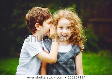 Foto stock: Boy Whispering To Firiend