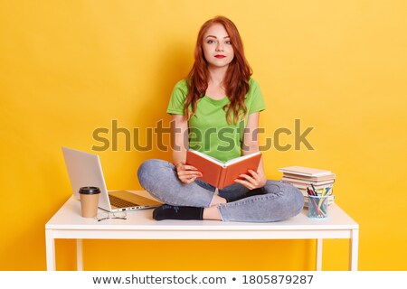 Stockfoto: Tired Red Haired Teenage Girl Studying At The Table